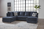 Blue sectional sofa with chaise and ottoman, patterned throw pillows