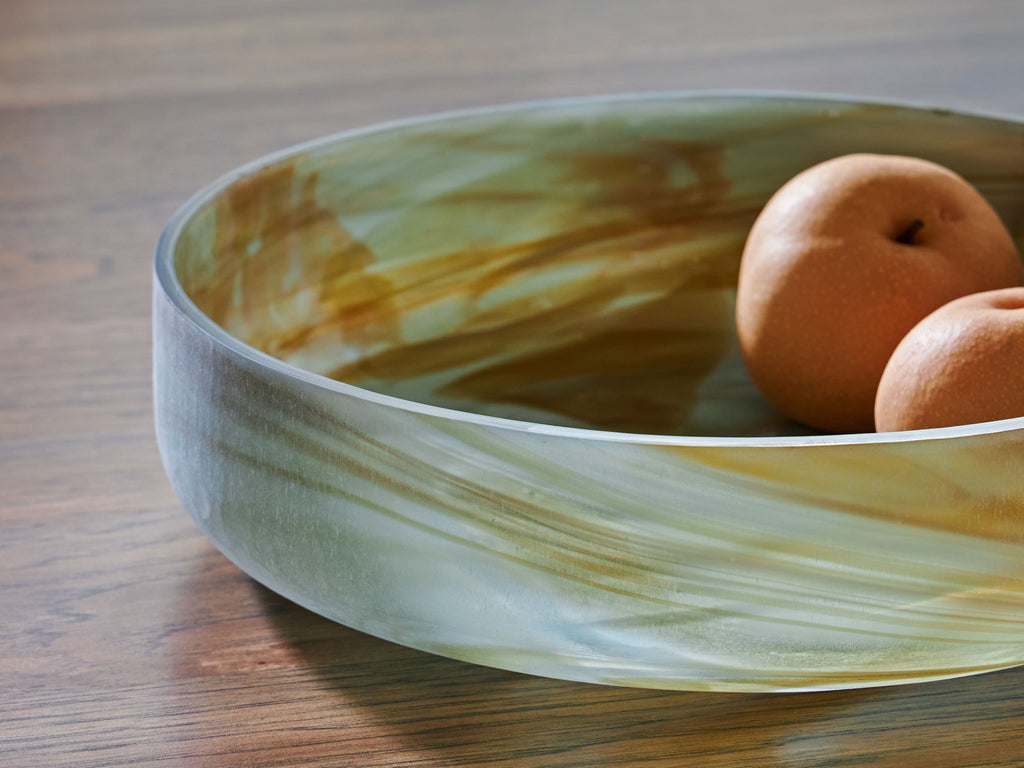 Sage green marbled glass bowl with round fruit inside