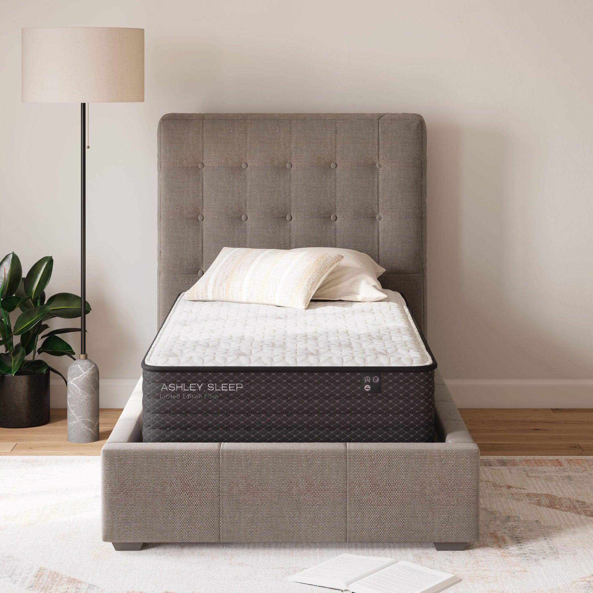 Plush mattress with quilted white top and tufted dark gray mattress edge