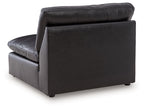 Black armless chair with thick cushions, smooth upholstery, and short legs