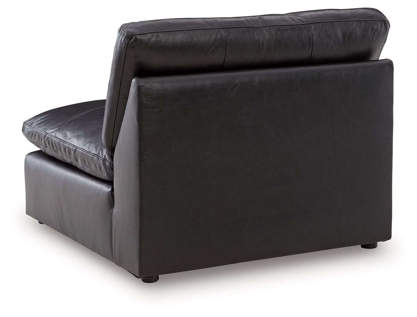 Black armless chair with thick cushions, smooth upholstery, and short legs