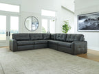 Sectional sofa with corner layout, tufted seat and back cushions in dark upholstery