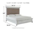 White upholstered platform bed with taupe button-tufted headboard and panel footboard.