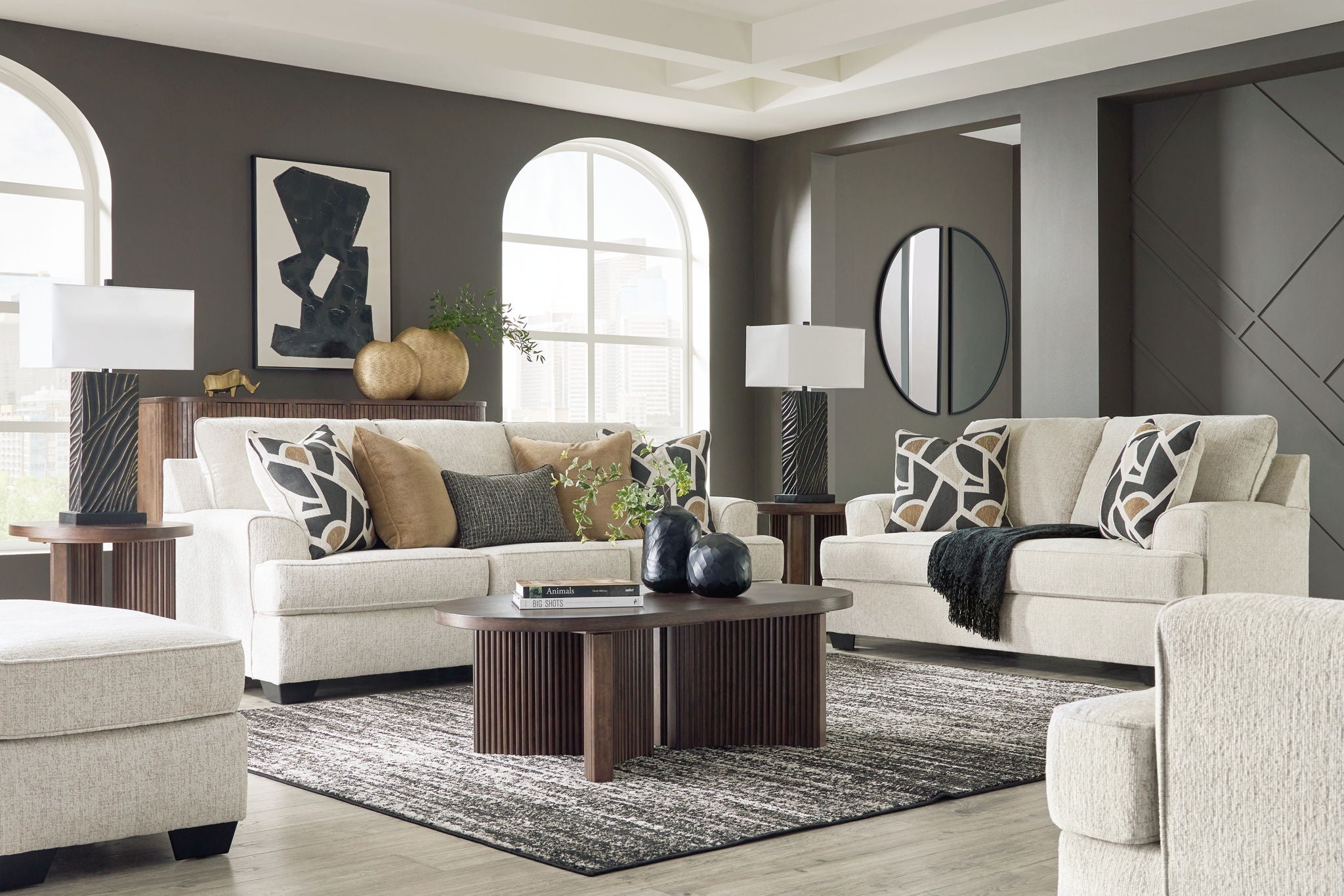 Beige upholstered seating set with sofa and chair, styled with throw pillows