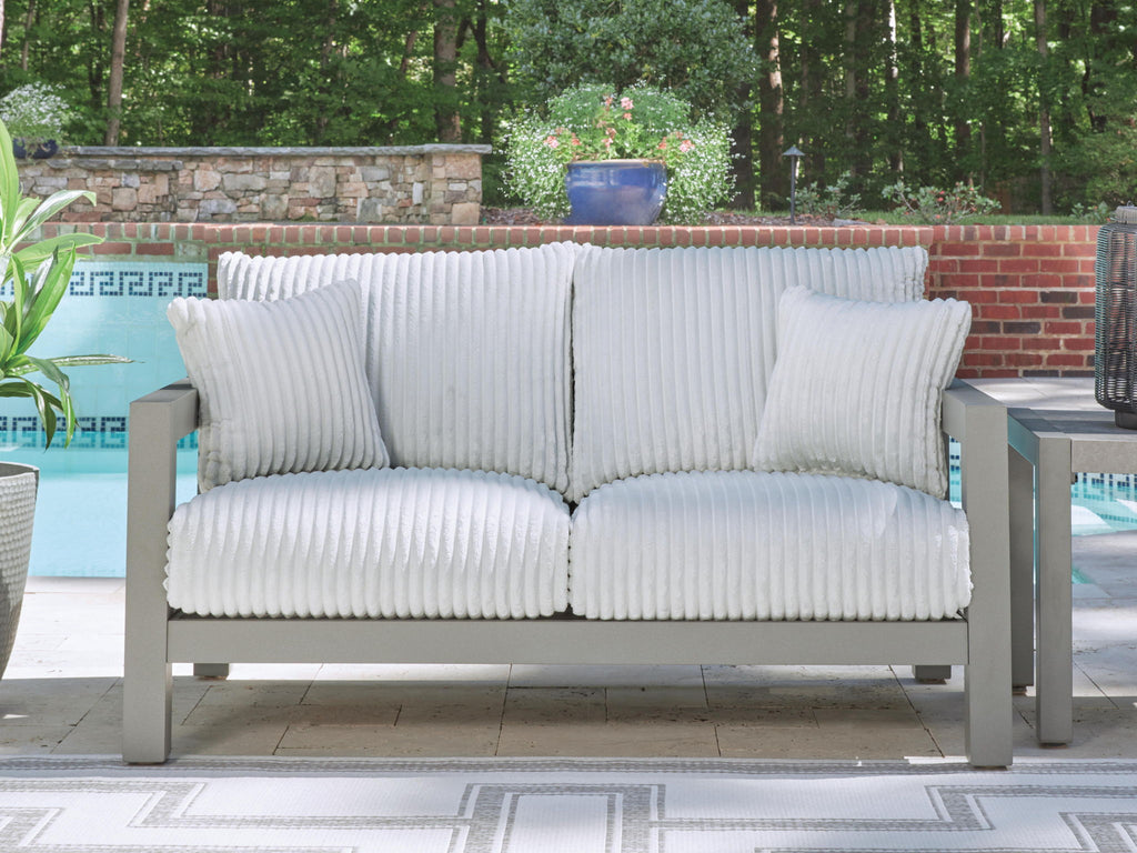 Gray loveseat with ribbed white seat and back cushions