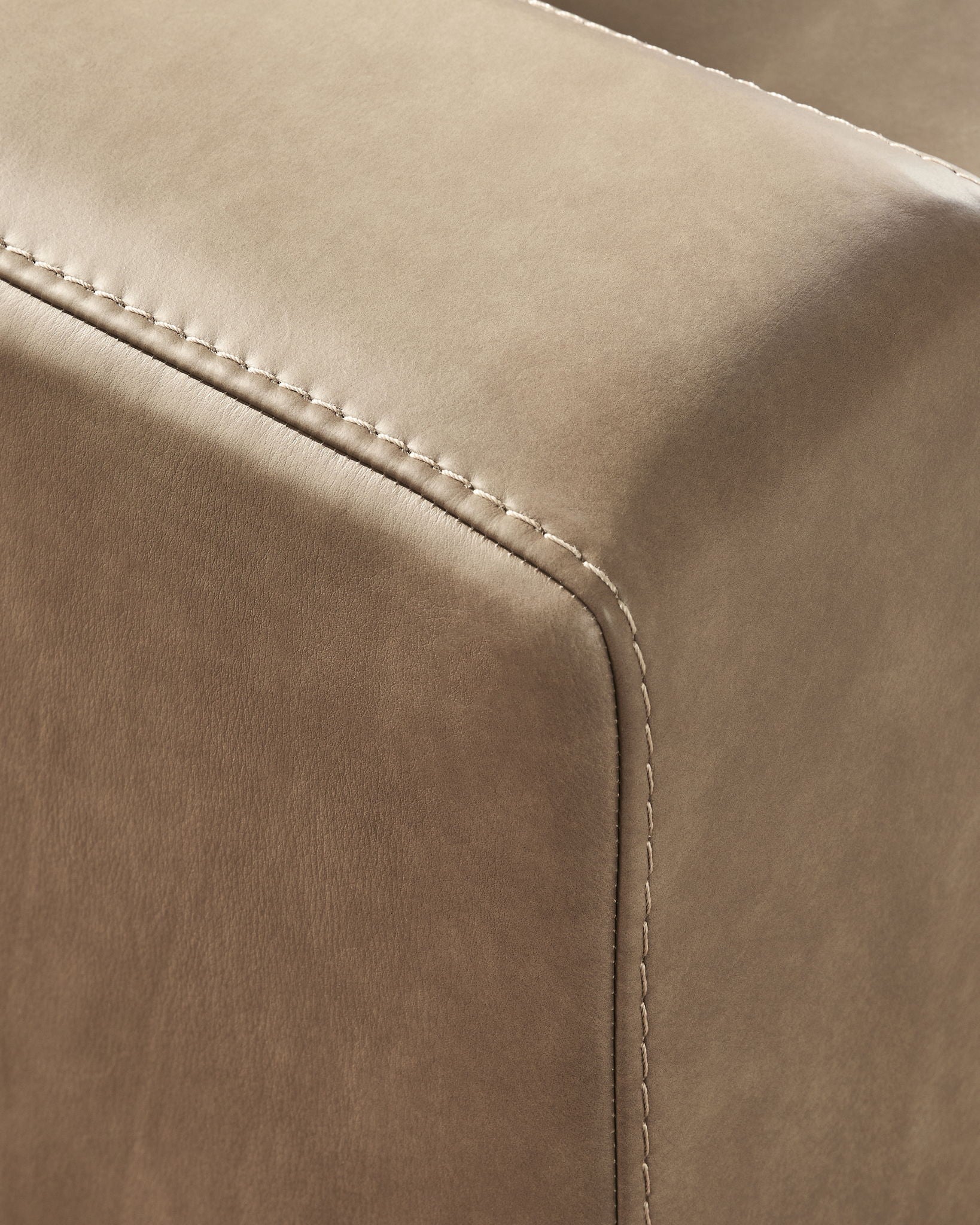 Sahara upholstered sofa arm with visible stitched seam and fabric edge