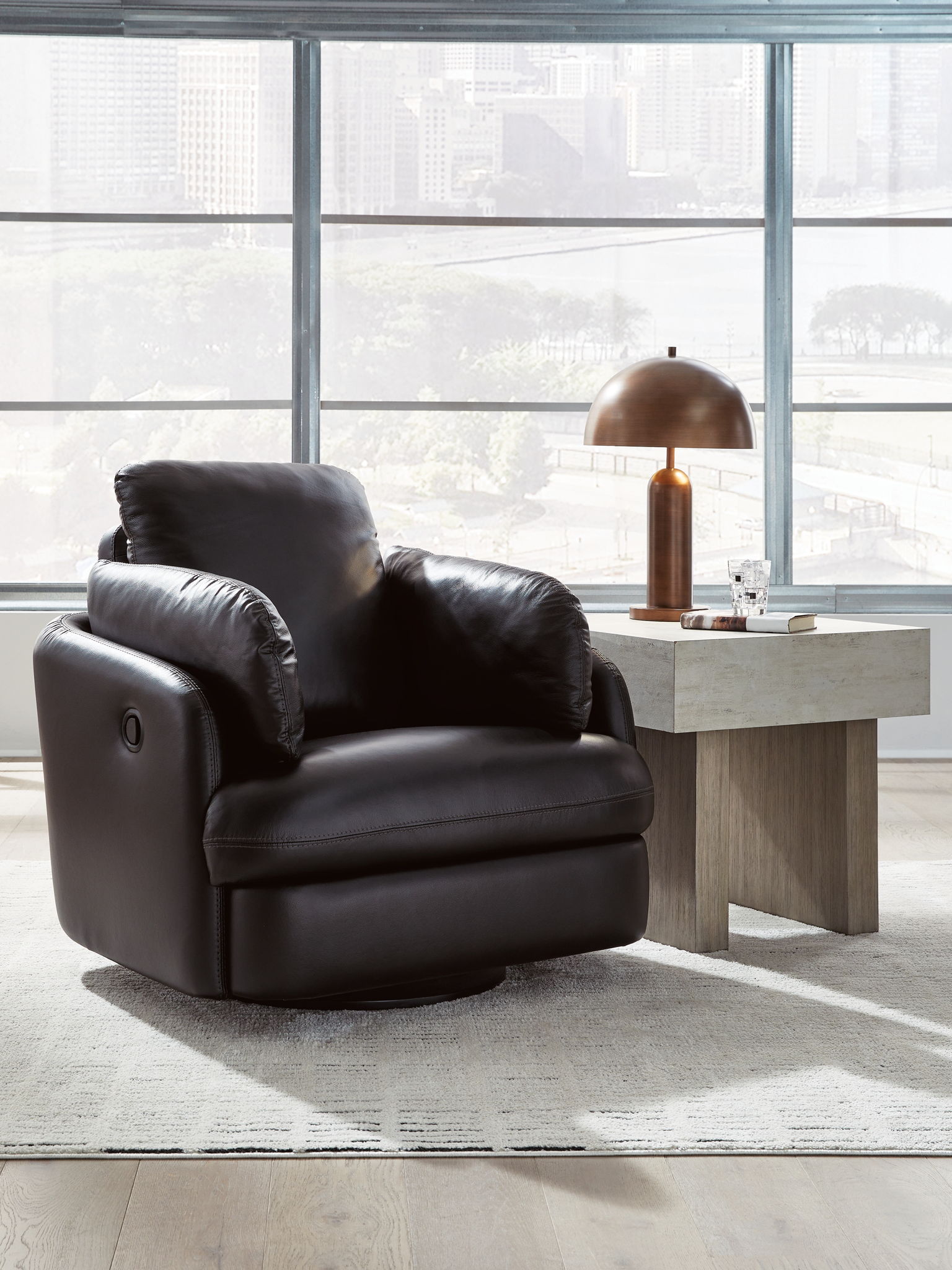 Black swivel glider recliner with wide seat, cushioned back, and side arms