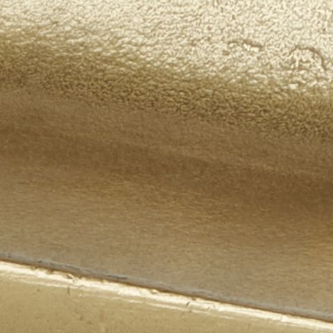 Gold-finish metal tray surface with smooth hammered texture