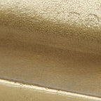 Gold-finish metal tray surface with smooth hammered texture