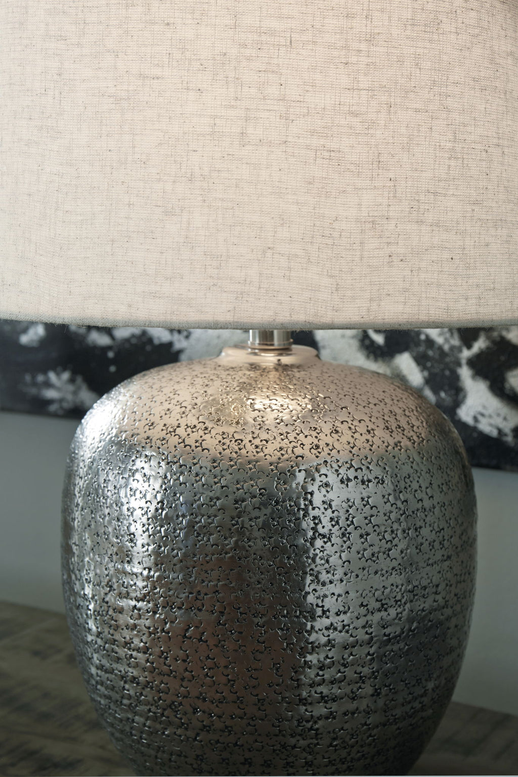 Antique silver metal table lamp base with beige drum shade, textured speckled finish