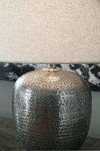 Antique silver metal table lamp base with beige drum shade, textured speckled finish