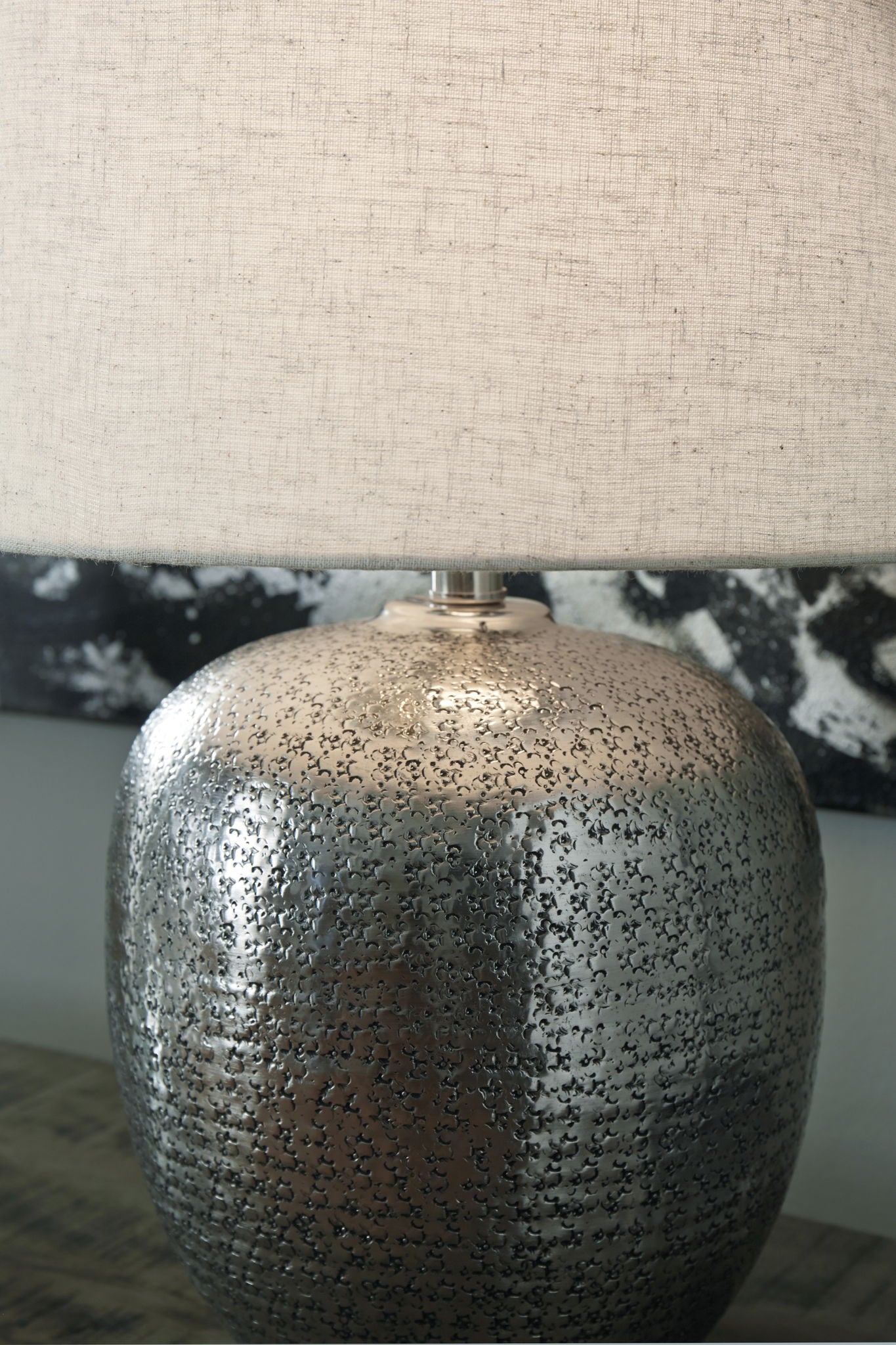 Antique silver metal table lamp base with beige drum shade, textured speckled finish