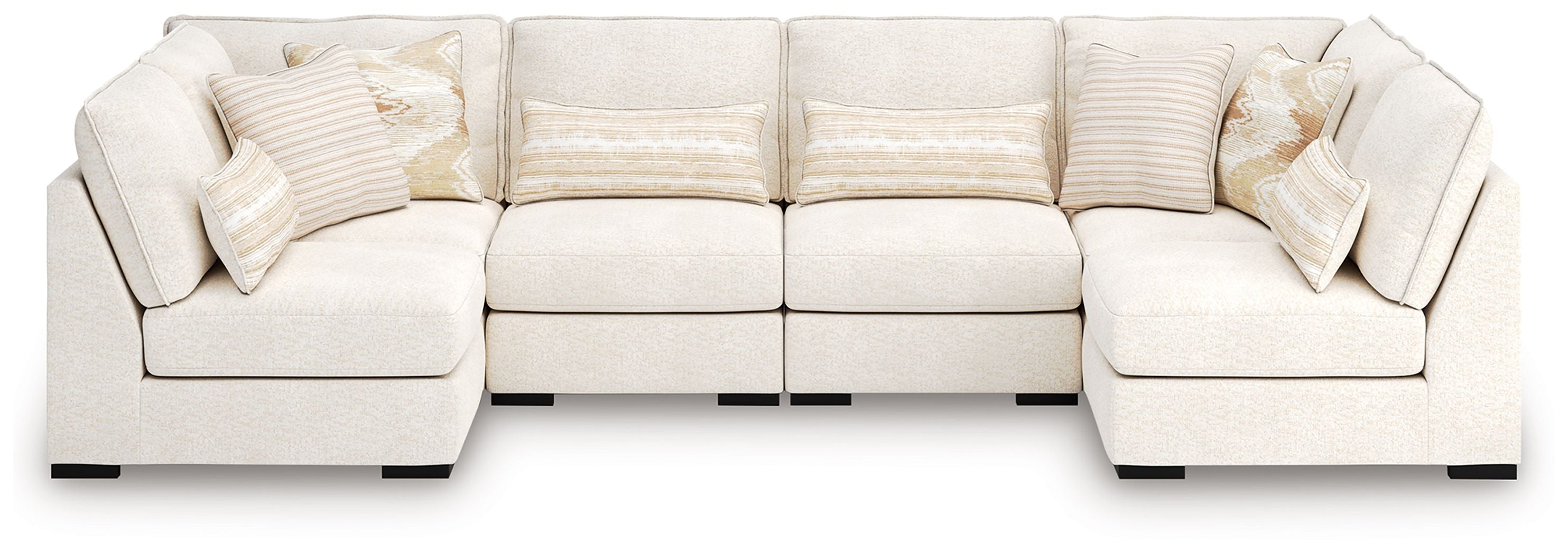 Vanilla sectional sofa with multiple seat cushions and matching patterned throw pillows