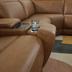 Caramel reclining sectional sofa with console and cupholders between seats