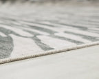 Gray and ivory washable rug with low-cut edge and subtle striped pattern near border