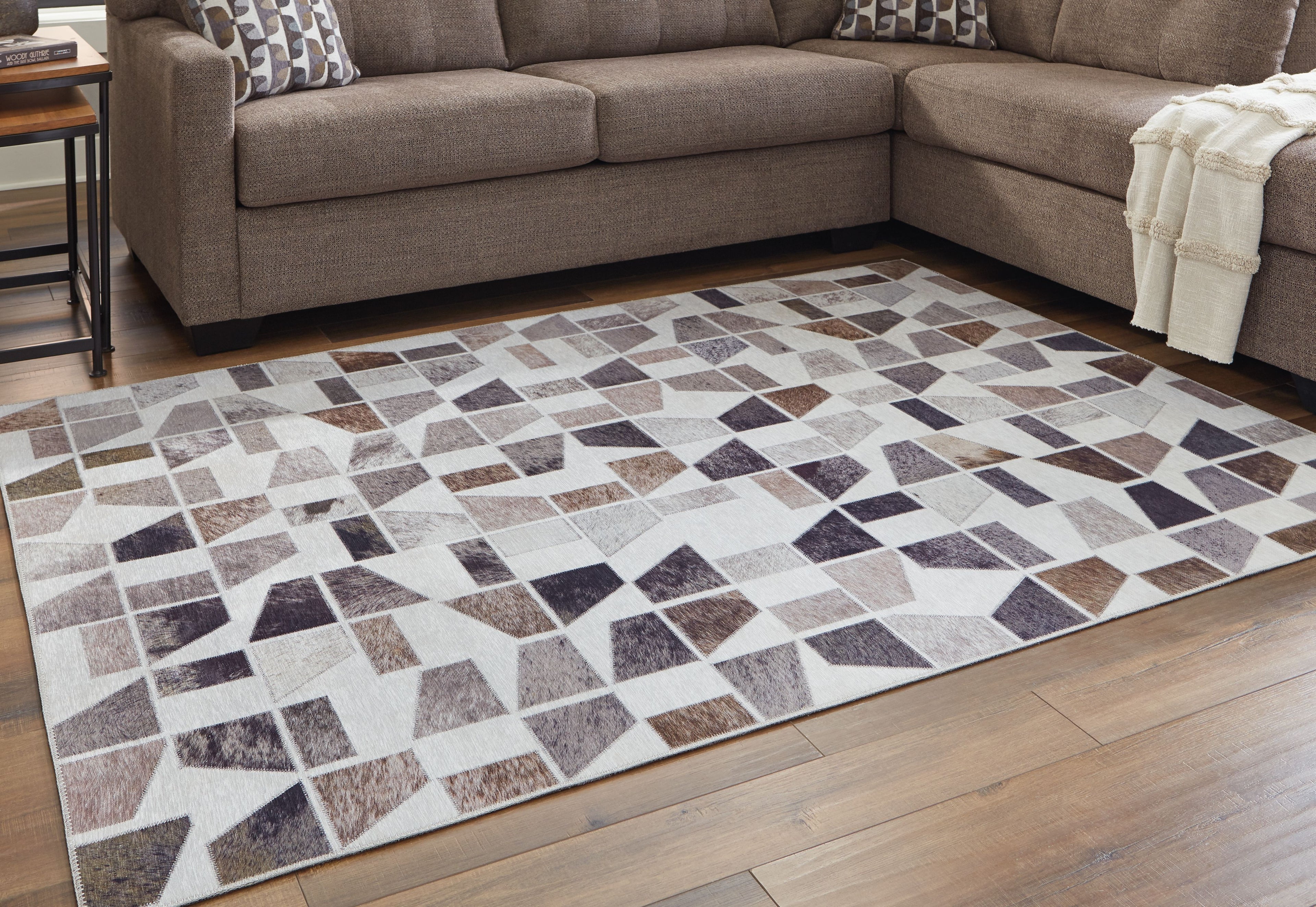Jettner area rug with abstract geometric pattern in gray, cream, navy, and brown