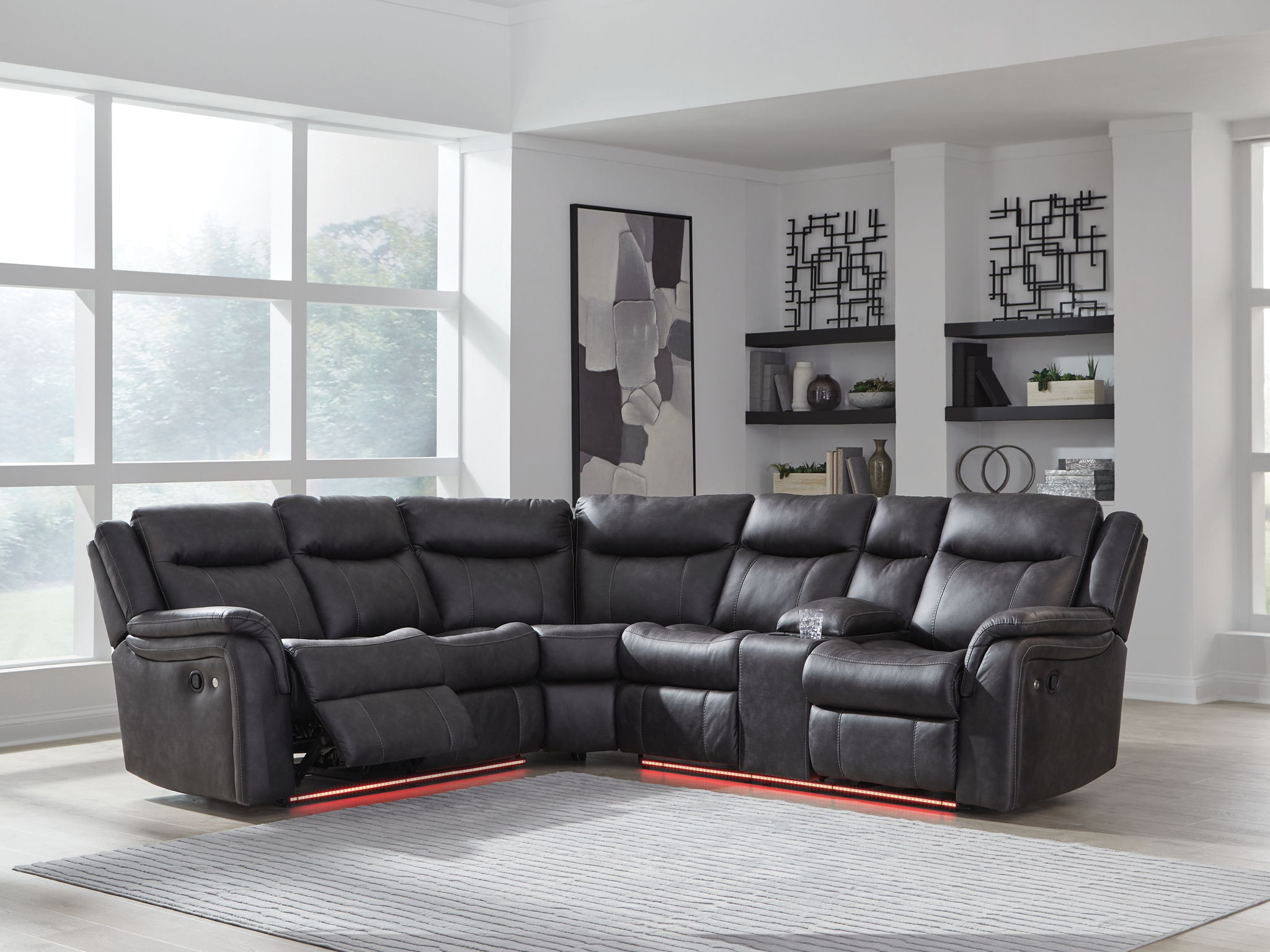 Dark carbon reclining sectional sofa in a corner layout with padded armrests and chaise seating.