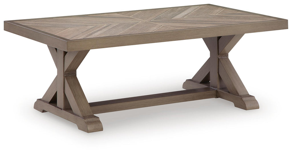 Beige rectangular cocktail table with beveled top and X-style support legs