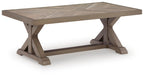 Beige rectangular cocktail table with beveled top and X-style support legs