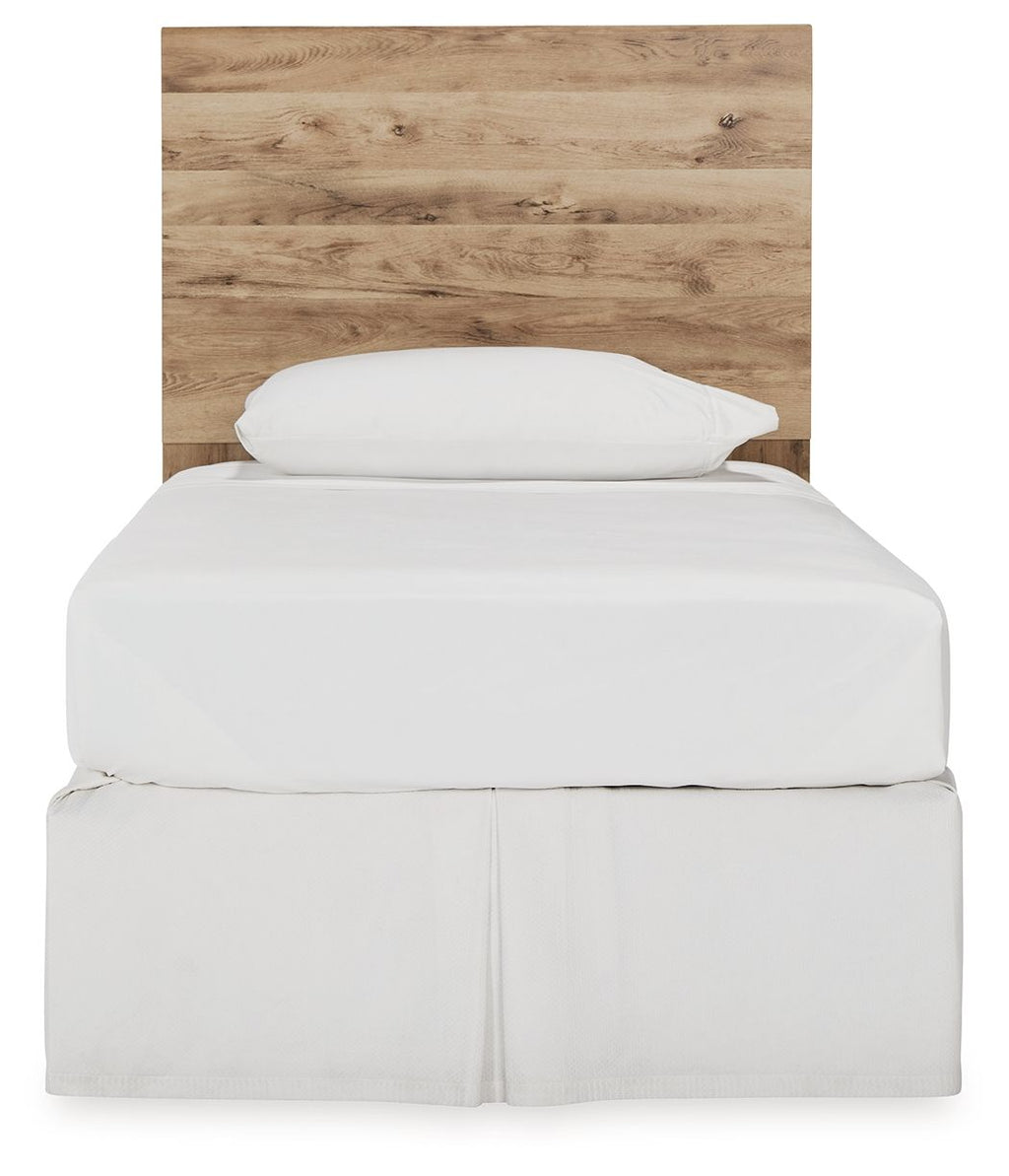 Beige wood panel headboard with arched top, behind white bed linens
