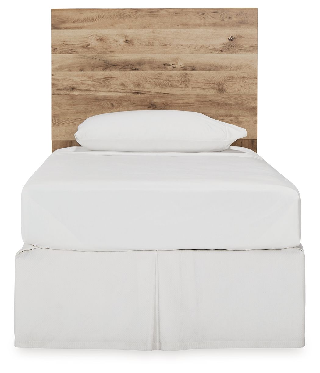 Beige wood panel headboard with arched top, behind white bed linens