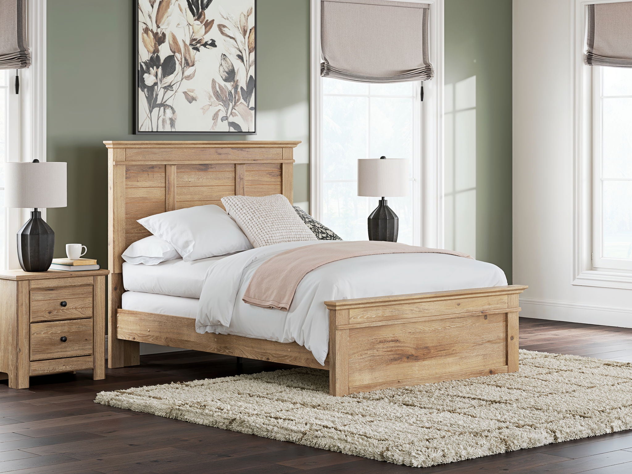 Light brown panel bed with tall headboard, white comforter, and decorative pillows.