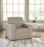 Light gray upholstered armchair with thick backrest and boxy silhouette