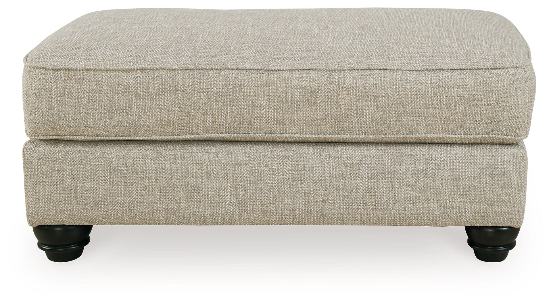 Fog beige ottoman with cushioned top, clean sides, and dark turned legs