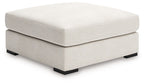 Vanilla upholstered accent ottoman with square top and dark legs