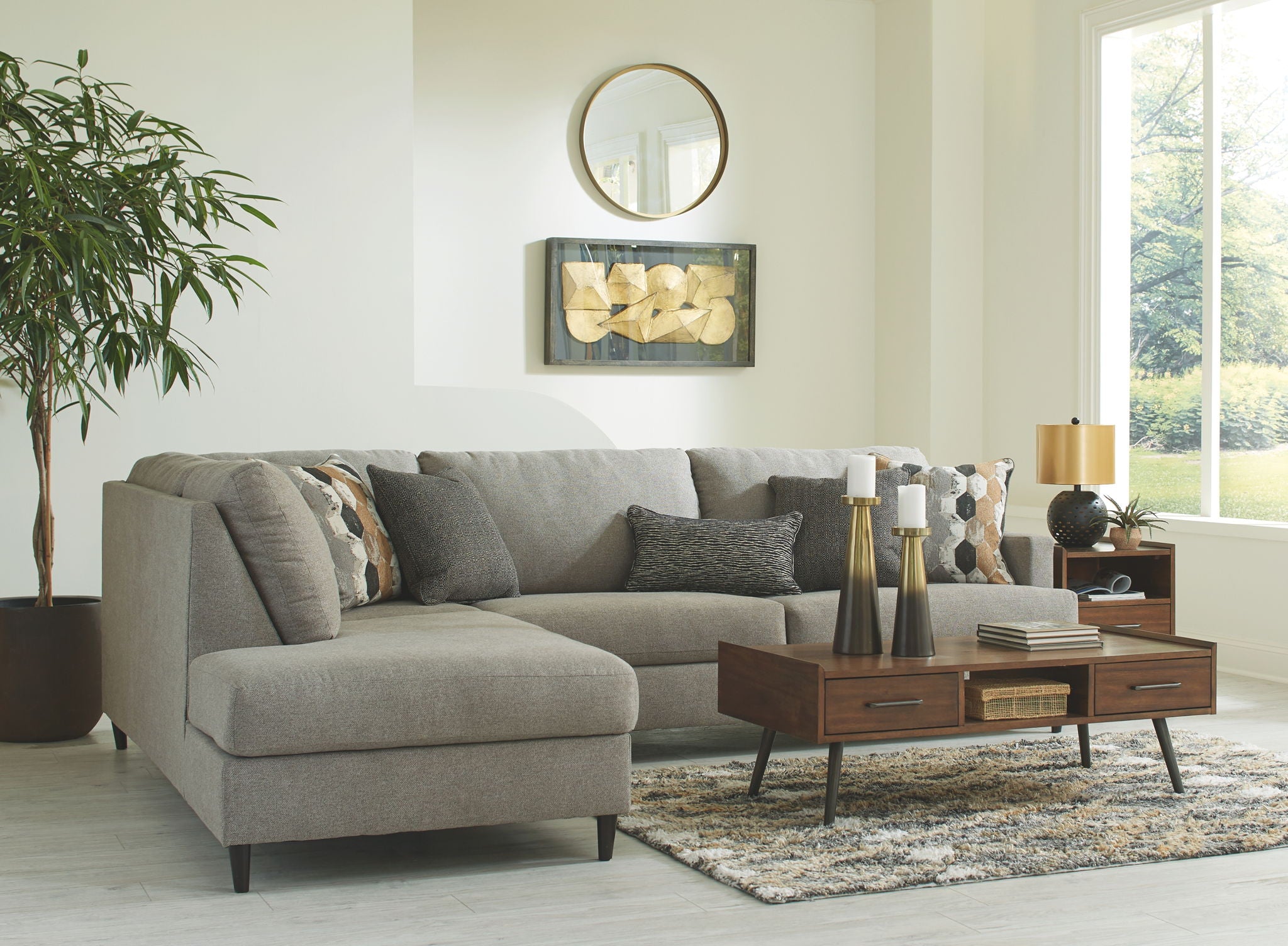 Granite gray fabric sectional sofa with chaise, rounded arms, and patterned accent pillows