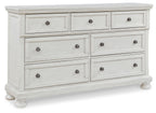 Antique white dresser with nine drawers and metal knobs, straight top rail.