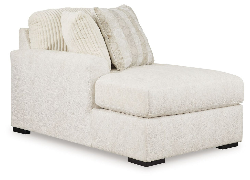 Ivory corner chaise with textured cushions and patterned throw pillows