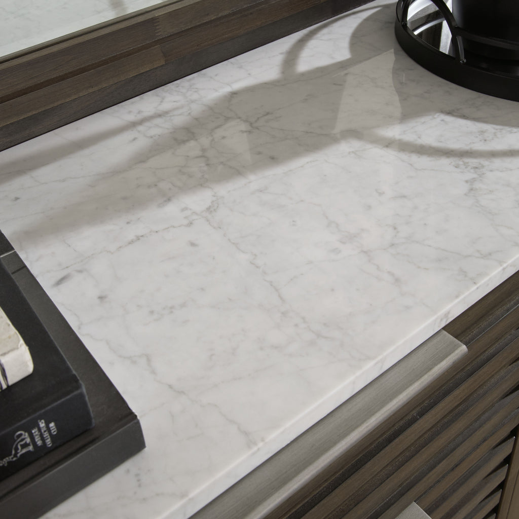 White marble dresser top with gray slatted drawer fronts and hardware