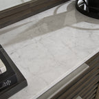 White marble dresser top with gray slatted drawer fronts and hardware