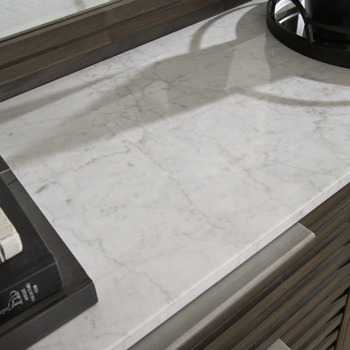 Dark brown dresser top with white marble surface and raised edge trim