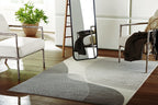 Winderburg rug with wavy stripe design in dark gray and light gray, on floor