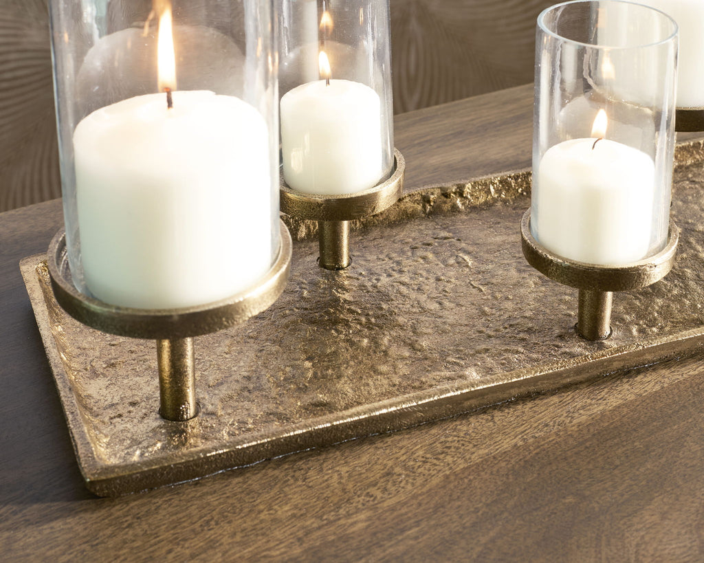 Antique brass candle holder tray with three lit white candles and glass holders