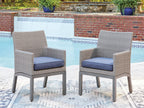 Pair of gray arm chairs with blue-gray seat cushions for outdoor seating.