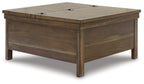 Lift-top cocktail table in grayish-brown wood with hinged top and drawer front