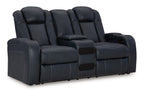 Dark blue power reclining loveseat with center console and padded headrests