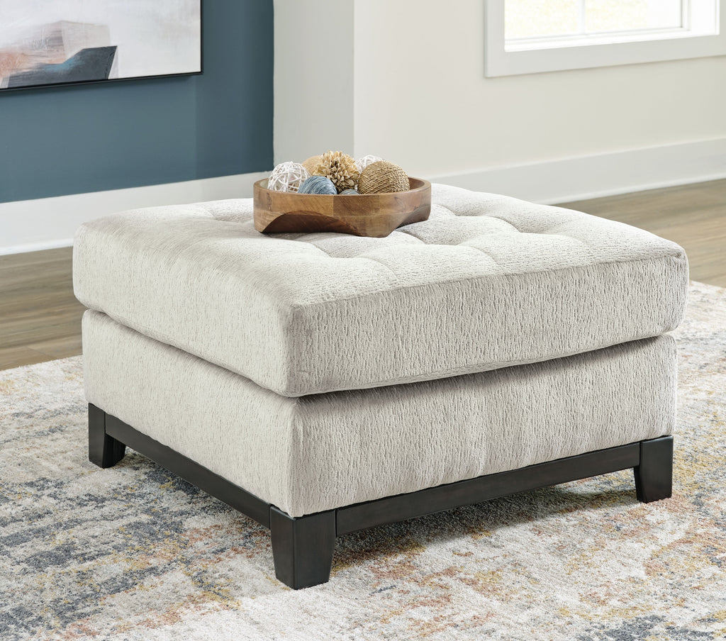 Beige oversized accent ottoman with tufted seat top and dark block feet