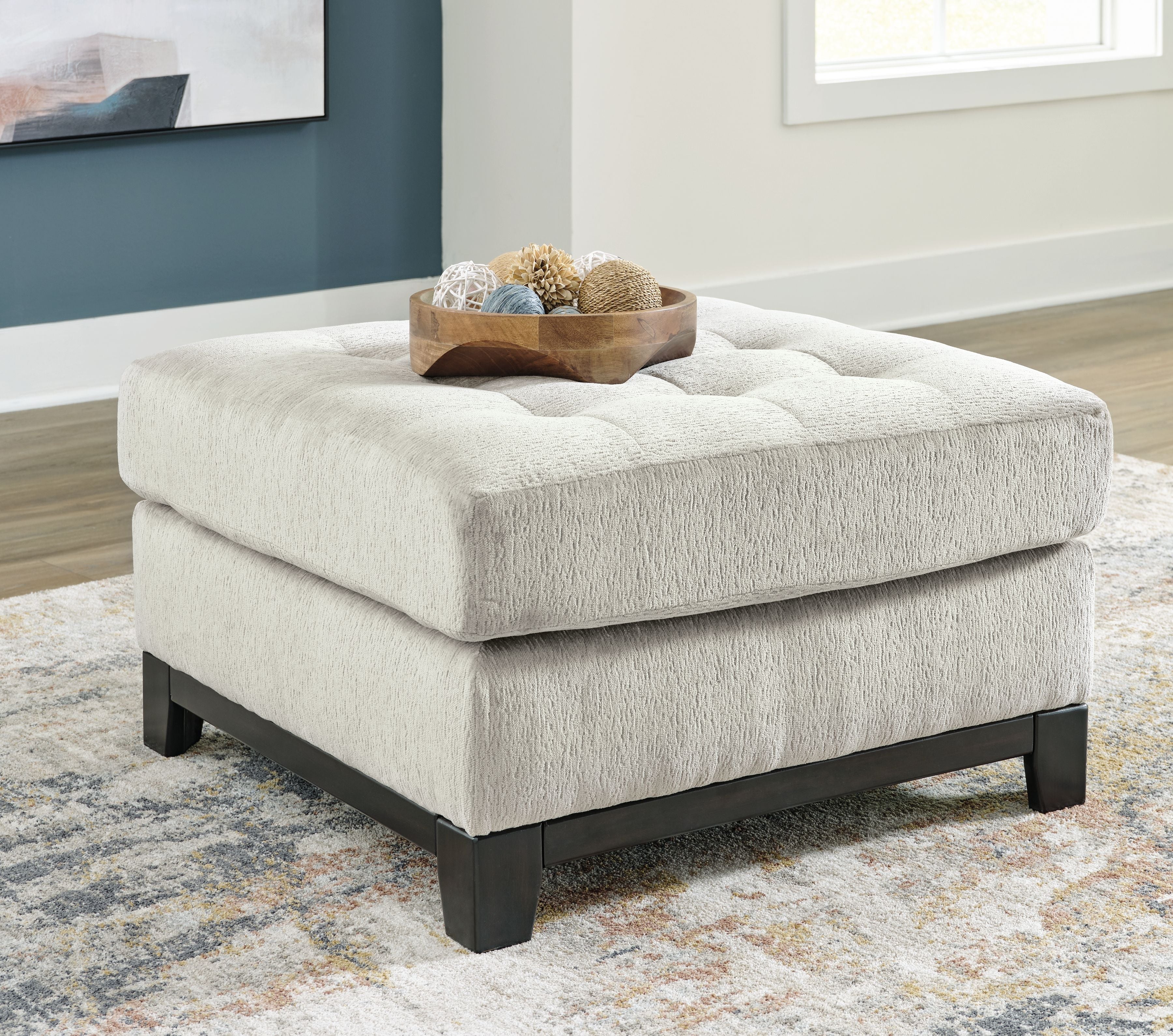 Beige oversized accent ottoman with tufted seat top and dark block feet