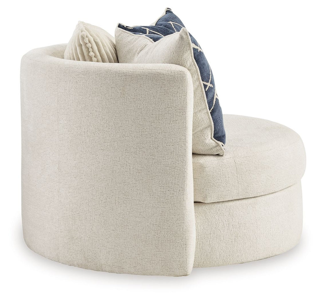 Ivory accent chair with rounded back and arm, navy throw pillow peeking over seat