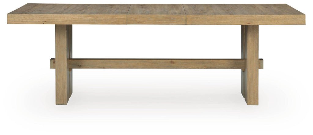 Light brown rectangular dining table with visible extension panels and apron-style sides