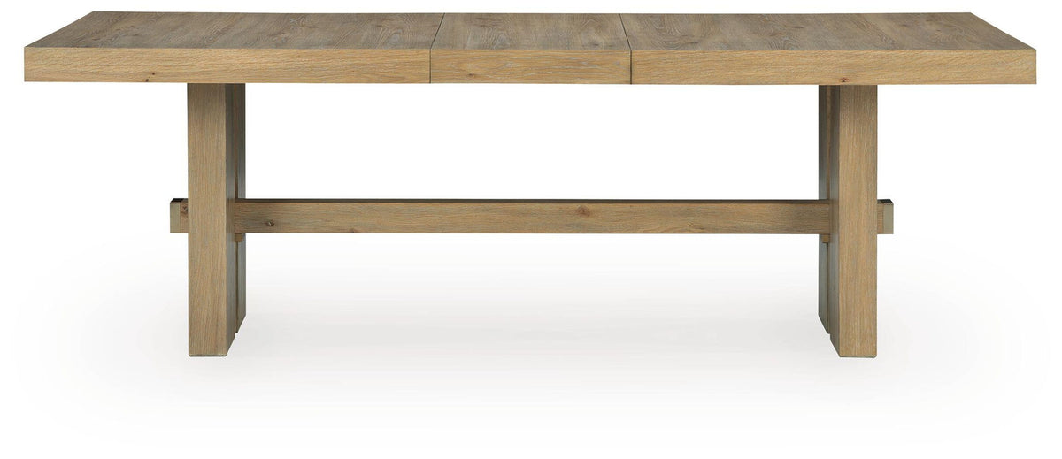 Light brown wood dining table with rectangular top and apron base