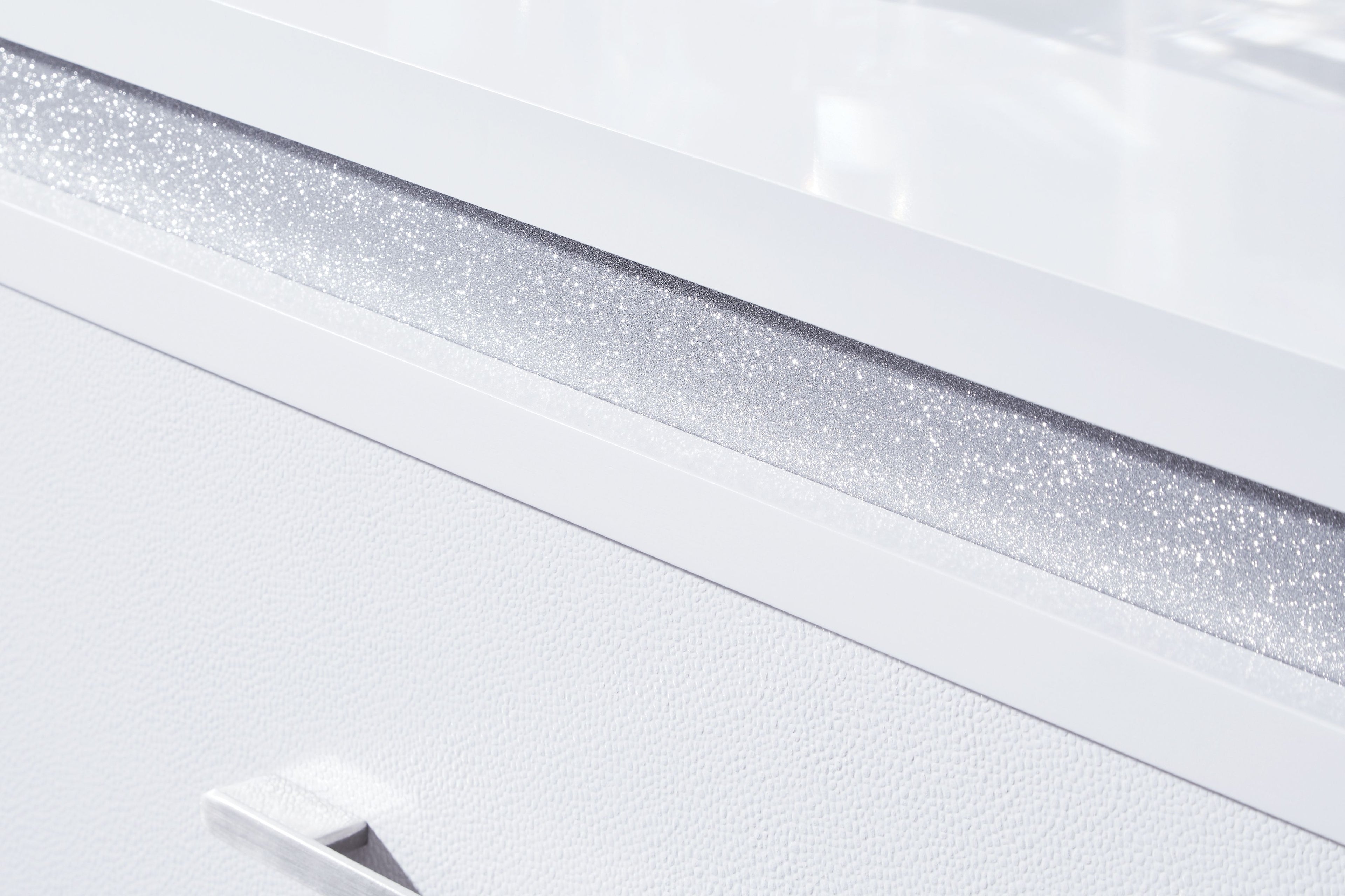 White tabletop edge with textured sparkle strip and straight silver drawer pull