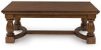 Rectangular brown cocktail table with two end pedestals and curved side frame