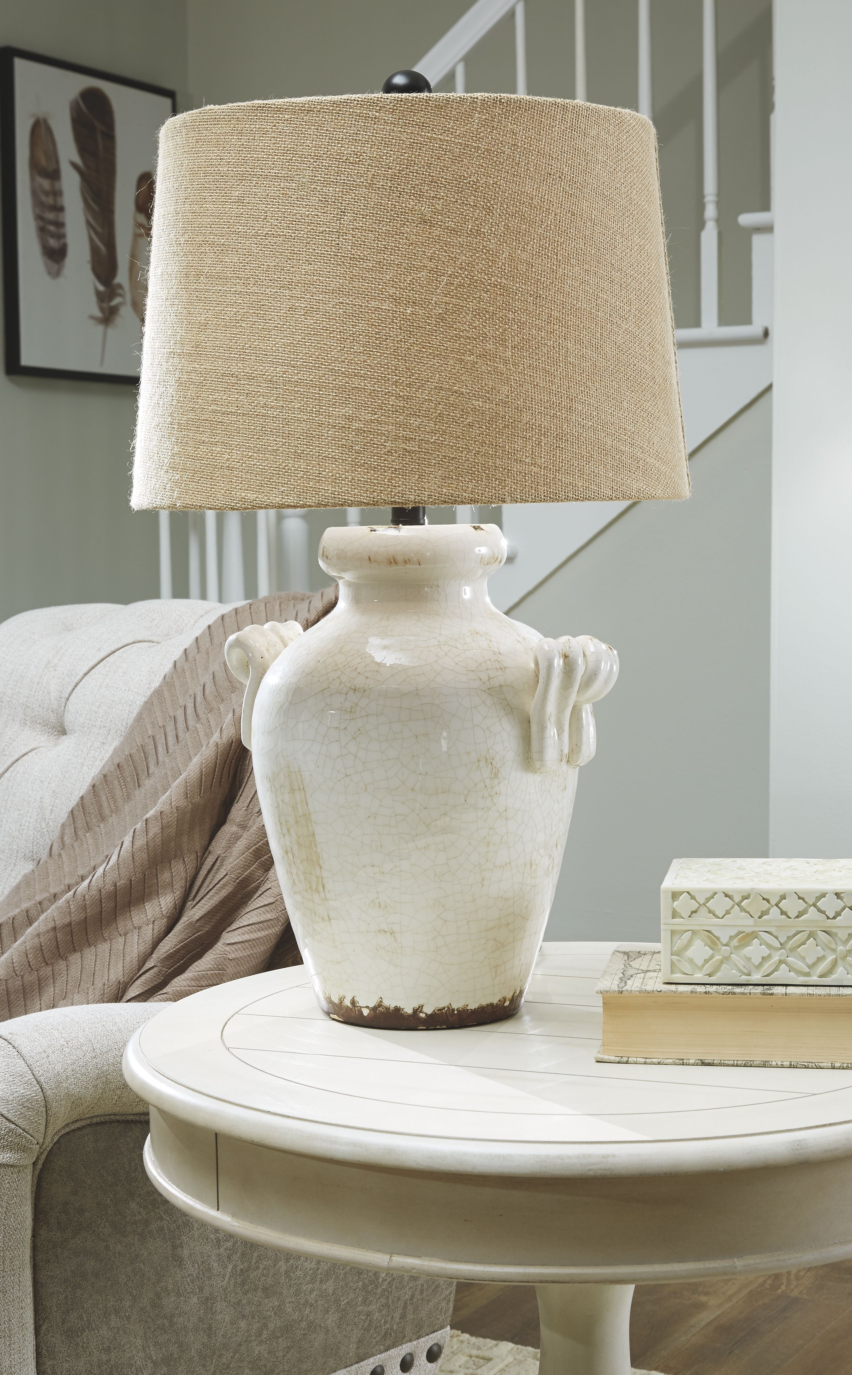 Cream ceramic table lamp with beige fabric drum shade, decorative handles