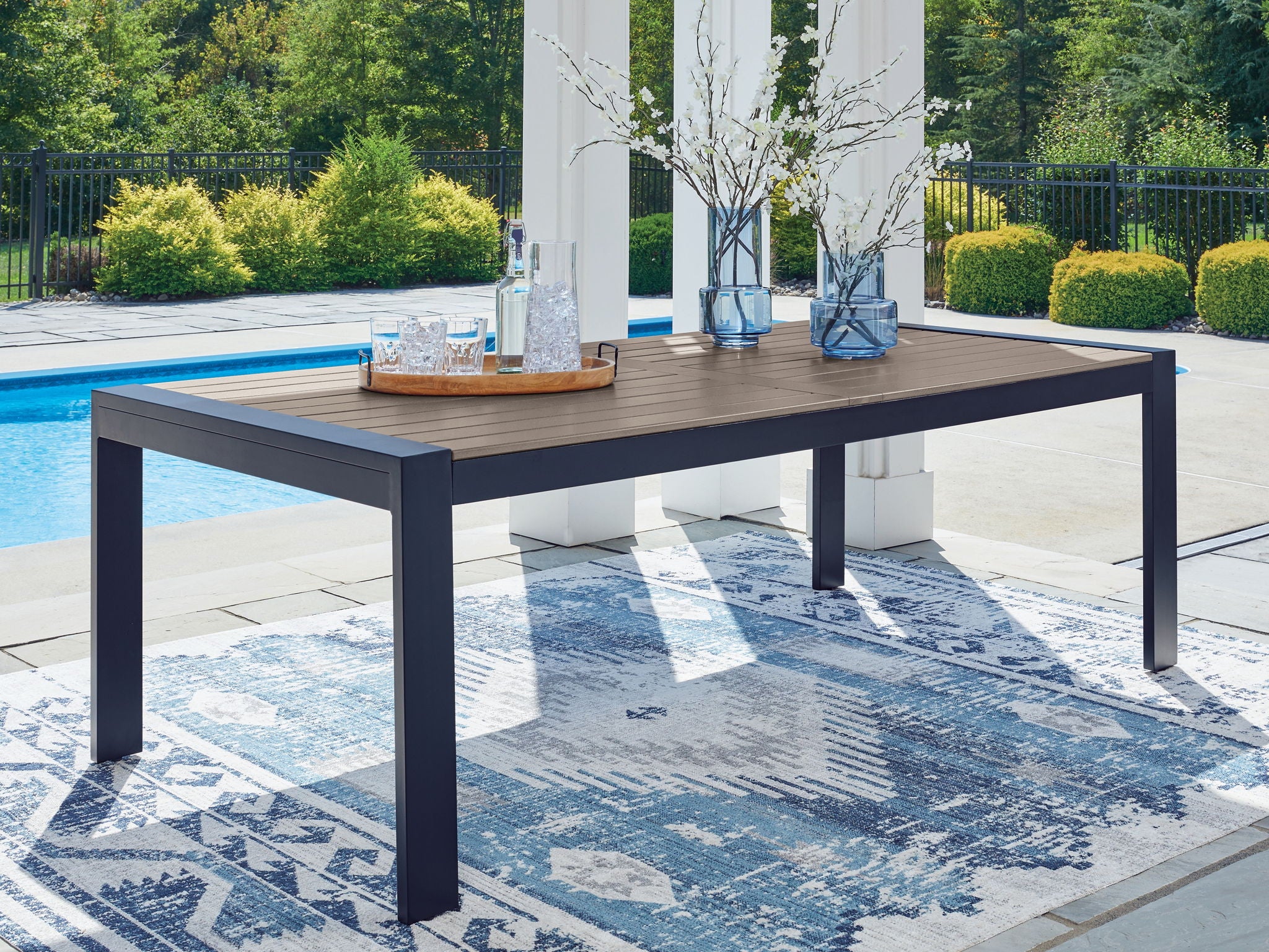 Rectangular outdoor dining table with slatted top and blue legs