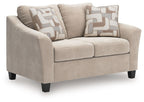 Taupe loveseat with two seat cushions and two patterned throw pillows